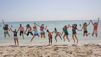 The Polk State College volleyball team shows its togetherness on Miami Beach before a tournament in September.