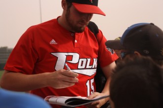 jucofirstwin2 Polk State Pitcher Alec Asher signs autographs after the Eagles win in the first round of the NJCAA JuCo World Series.
